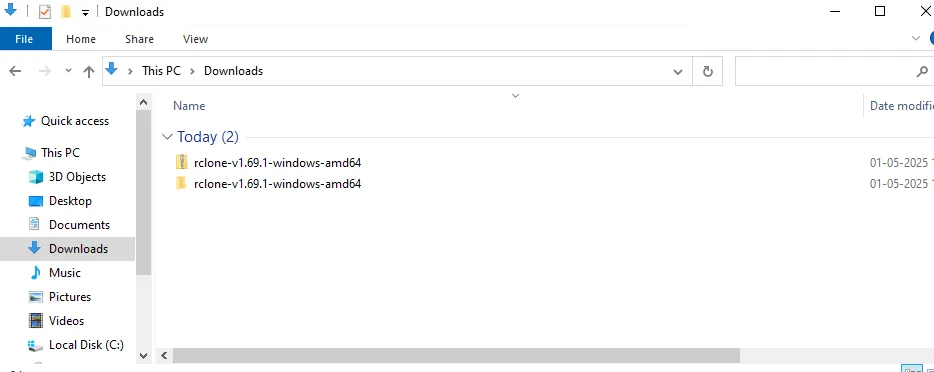 Downloads folder showing the rclone zip file and the extracted rclone folder
